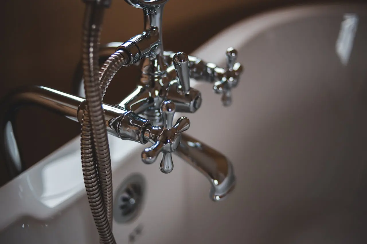 Elegant close-up of a shiny chrome faucet in a modern bathroom setting.